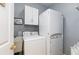 Laundry room including a washer, dryer and cabinet storage at 4557 Waldens Farm Ct, Powder Springs, GA 30127