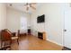 Versatile living space featuring a decorative fireplace and a wall-mounted TV at 4557 Waldens Farm Ct, Powder Springs, GA 30127