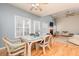 Open-concept living room and dining area with a fireplace, light wood floors, and lots of natural light at 4557 Waldens Farm Ct, Powder Springs, GA 30127
