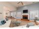 Spacious living room featuring hardwood floors, a fireplace, and lots of natural light from a multitude of windows at 4557 Waldens Farm Ct, Powder Springs, GA 30127