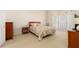 Spacious main bedroom featuring large windows, soft carpeting, and a decorative dresser at 4557 Waldens Farm Ct, Powder Springs, GA 30127