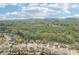An aerial view of a quaint neighborhood with well-maintained homes and tree-lined streets at 6060 Country Lake Rd, Cumming, GA 30041