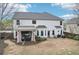 Exterior shot of a home with a cozy patio, outdoor seating, and a well-manicured backyard at 6060 Country Lake Rd, Cumming, GA 30041