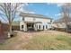 Back of house shows covered patio, grill area, and a small trampoline in the yard at 6060 Country Lake Rd, Cumming, GA 30041