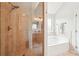 Bright bathroom featuring glass shower and large soaking tub at 6060 Country Lake Rd, Cumming, GA 30041