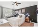 A teenager's bedroom featuring a basketball hoop, a football, and a ceiling fan at 6060 Country Lake Rd, Cumming, GA 30041