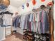 Spacious walk-in closet featuring metal racking with shoes and color coordinated garments at 6060 Country Lake Rd, Cumming, GA 30041