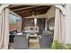 Inviting covered patio featuring cozy seating, ceiling fan, and stylish decor at 6060 Country Lake Rd, Cumming, GA 30041