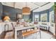Elegant dining room with wainscoting, stylish lighting fixture, and a view of the outdoors at 6060 Country Lake Rd, Cumming, GA 30041