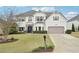 Charming two-story home with a well-manicured lawn, two-car garage, and beautiful landscaping at 6060 Country Lake Rd, Cumming, GA 30041