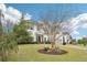 Well-maintained two-story home with a green lawn, a driveway, and an attached garage at 6060 Country Lake Rd, Cumming, GA 30041
