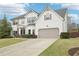Well-maintained two-story home with manicured lawn, extended driveway, and an attached garage at 6060 Country Lake Rd, Cumming, GA 30041