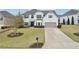 Charming two-story home with manicured lawn, gray shutters, and attached garage at 6060 Country Lake Rd, Cumming, GA 30041