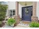 Close up of inviting front porch with adirondack chairs, brick accents and stylish door at 6060 Country Lake Rd, Cumming, GA 30041