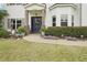 Inviting front porch with lush landscaping, elegant columns, and a stylish front door at 6060 Country Lake Rd, Cumming, GA 30041