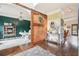 Entryway featuring hardwood floors, barn door to office, and view to kitchen and living area at 6060 Country Lake Rd, Cumming, GA 30041