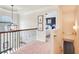 Upstairs hallway with decorative railing, trim work, and pendant lighting at 6060 Country Lake Rd, Cumming, GA 30041