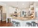 Bright kitchen features granite countertops, white cabinets, stainless steel appliances, and pendant lighting at 6060 Country Lake Rd, Cumming, GA 30041