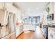 Bright kitchen featuring granite countertops, stainless steel appliances, and an open layout to the living area at 6060 Country Lake Rd, Cumming, GA 30041