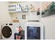 Functional laundry room equipped with a washer, dryer, and ample shelving for storage at 6060 Country Lake Rd, Cumming, GA 30041
