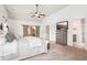 Spacious main bedroom with barn doors to sitting area; natural light, TV, and vaulted ceiling at 6060 Country Lake Rd, Cumming, GA 30041