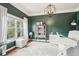 Home office featuring dark green walls, natural light, and decorative chandelier at 6060 Country Lake Rd, Cumming, GA 30041