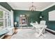 Home office featuring dark green walls, natural light, and decorative chandelier at 6060 Country Lake Rd, Cumming, GA 30041