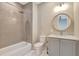 Bathroom features a tub and shower, granite countertop, gray vanity, and neutral paint at 1130 Lupo Loop, Chattahoochee Hills, GA 30268