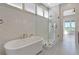 Chic bathroom featuring herringbone tile, a freestanding tub, and a glass-enclosed shower at 1130 Lupo Loop, Chattahoochee Hills, GA 30268