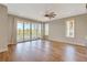 Spacious bedroom with hardwood floors, fan, and doors leading to a private outdoor balcony at 1130 Lupo Loop, Chattahoochee Hills, GA 30268