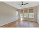 Light filled bedroom with hardwood floors and three large windows with natural wood shades at 1130 Lupo Loop, Chattahoochee Hills, GA 30268