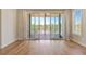 Bedroom with sliding glass doors leading to covered porch, hardwood flooring, fan, and neutral paint at 1130 Lupo Loop, Chattahoochee Hills, GA 30268