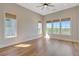 Sunlit bedroom featuring large windows, hardwood floors, and modern window shades at 1130 Lupo Loop, Chattahoochee Hills, GA 30268