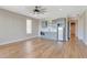 Light-filled bonus room with modern wet bar and neutral gray cabinets, and hardwood floors at 1130 Lupo Loop, Chattahoochee Hills, GA 30268