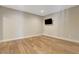 Versatile bonus room with hardwood flooring and a wall-mounted television at 1130 Lupo Loop, Chattahoochee Hills, GA 30268