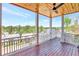 Covered porch with open view of neighborhood, white railings, and painted wood plank ceiling at 1130 Lupo Loop, Chattahoochee Hills, GA 30268