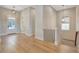 Bright entryway with hardwood floors, staircase, and a view of the front door at 1130 Lupo Loop, Chattahoochee Hills, GA 30268