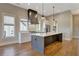 Bright kitchen with a large island, stainless steel appliances, and stylish pendant lighting at 1130 Lupo Loop, Chattahoochee Hills, GA 30268