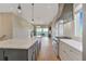 Open-concept kitchen with large island, stainless steel appliances, and hardwood flooring at 1130 Lupo Loop, Chattahoochee Hills, GA 30268