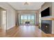 Bright living room with fireplace, large sliding doors with great view, and hardwood floors at 1130 Lupo Loop, Chattahoochee Hills, GA 30268