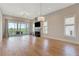 Spacious living room with hardwood floors, fireplace, and access to outdoor patio at 1130 Lupo Loop, Chattahoochee Hills, GA 30268