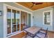 Cozy patio with wood flooring, fan, and table, offering a relaxing outdoor space at 1130 Lupo Loop, Chattahoochee Hills, GA 30268