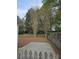 Serene backyard featuring mature trees, a wooden fence, and a neatly covered ground at 2012 Grove Park Ct, Marietta, GA 30062
