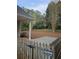 Private backyard with a small patio, wooden fence, and a sign for Glover Fence at 2012 Grove Park Ct, Marietta, GA 30062