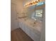 A vanity with double sinks and a large mirror reflects the bathroom features, tub, and stained glass at 2012 Grove Park Ct, Marietta, GA 30062