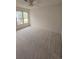 Bright bedroom with a ceiling fan and large window providing ample natural light at 2012 Grove Park Ct, Marietta, GA 30062