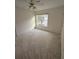 Bright, carpeted bedroom with a ceiling fan and natural light at 2012 Grove Park Ct, Marietta, GA 30062