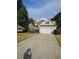A beautiful, well-maintained home featuring a two-car garage and a long driveway at 2012 Grove Park Ct, Marietta, GA 30062
