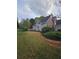A well landscaped side yard with a mix of mature trees and manicured lawn at 2012 Grove Park Ct, Marietta, GA 30062