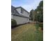 View of the rear exterior of the house with well-maintained lawn and trimmed hedges at 2012 Grove Park Ct, Marietta, GA 30062